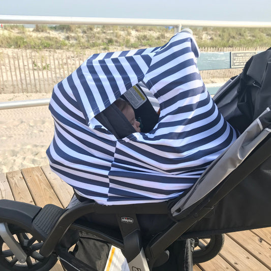 Cobertor para coche de bebé con SPF 50+ diseñado para proteger del sol, el viento y dar comodidad a los bebés.