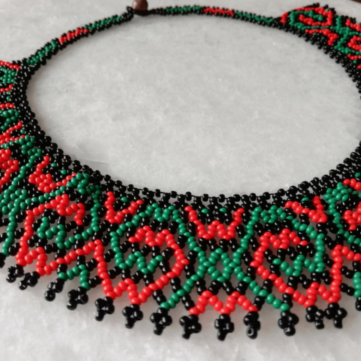 Collar de Cuentas Verde y Coral con diseño geométrico.