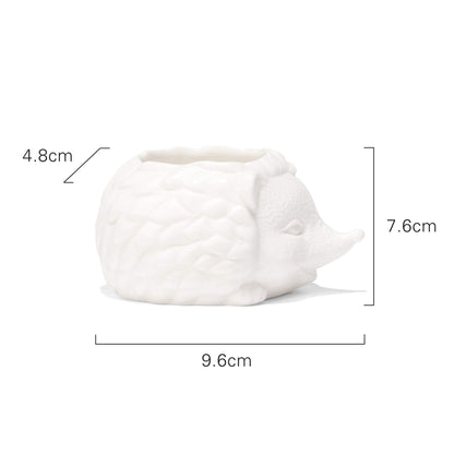Macetita en forma de erizo de cerámica, ideal para plantas pequeñas y como decoración de escritorio.